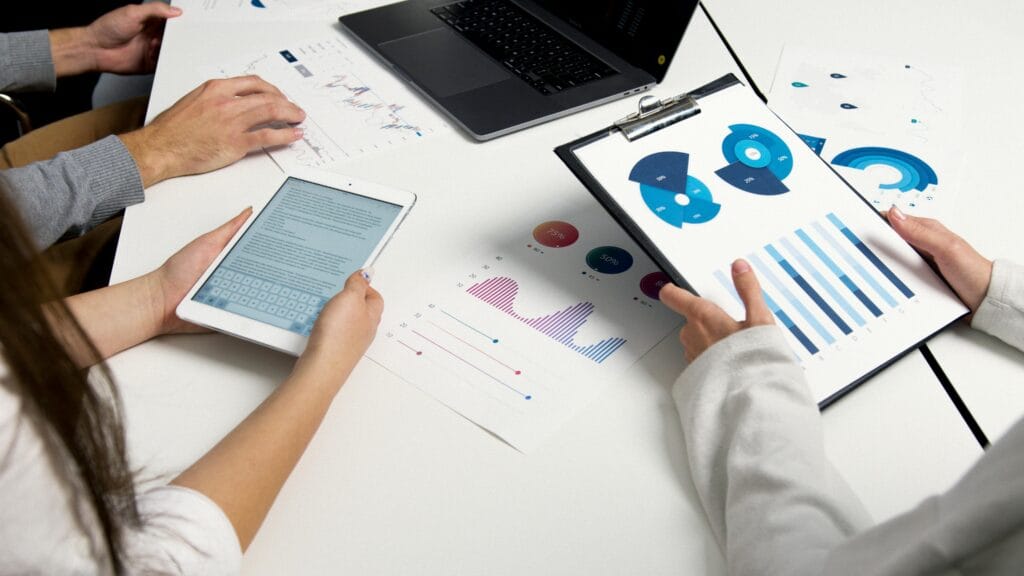 pexels-photo-5716032-5716032 Team analyzing financial charts and digital reports during a business meeting.