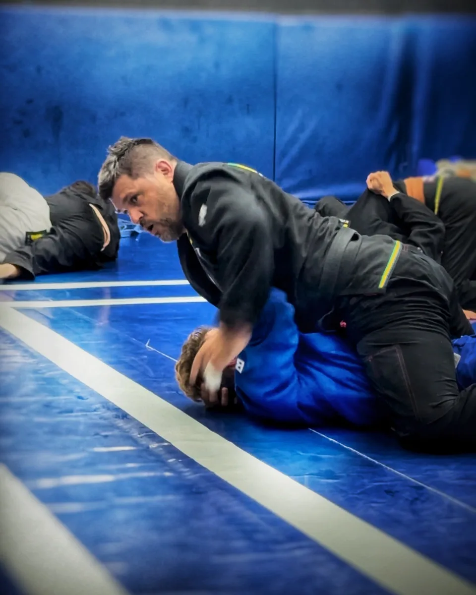 Faith and Flow Jiu-Jitsu coach on the mats during training