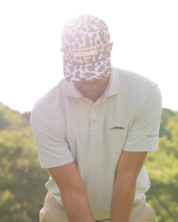 Golfer addressing the ball in a High Handy Caps hat