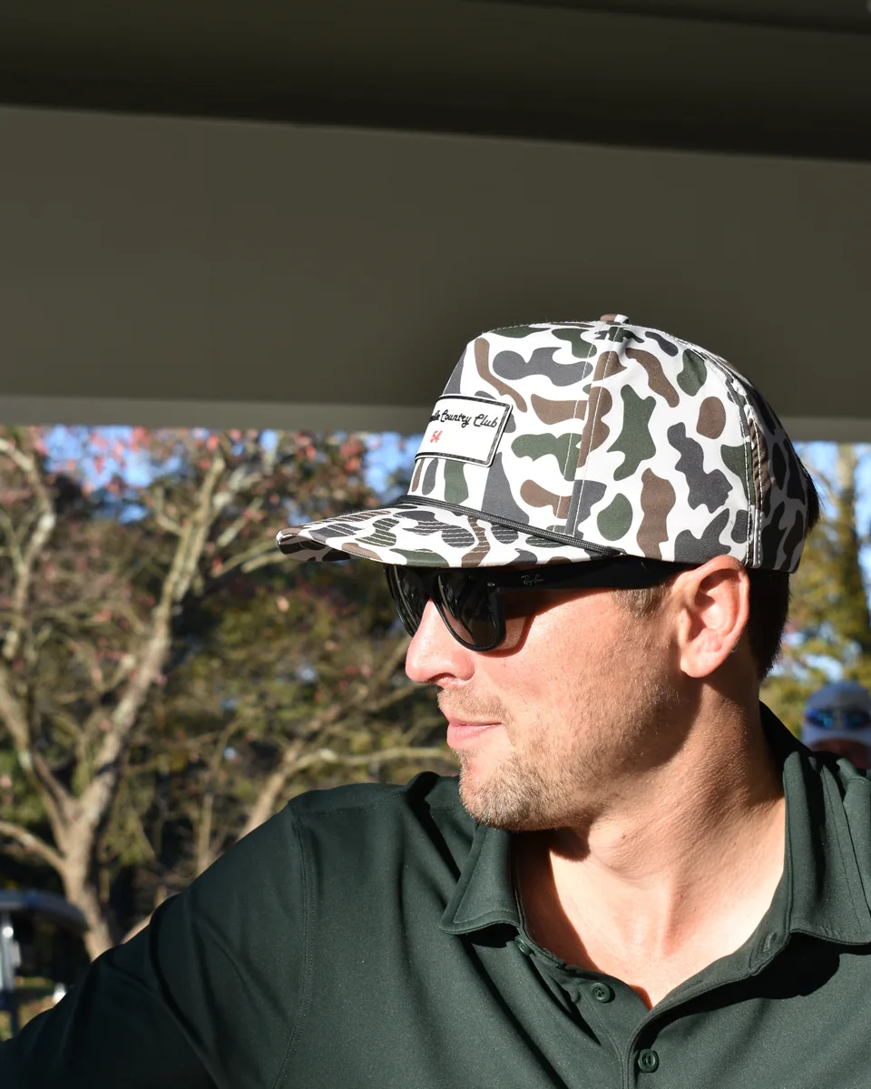 Golfer wearing a High Handy Caps camo rope hat